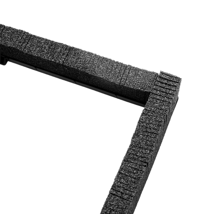 Close-up of a black textured foam frame corner on a solid white background.