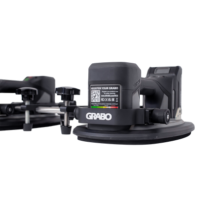 A black GRABO industrial laser level attachment with a circular base and adjustment knobs, shown on a clean white background.